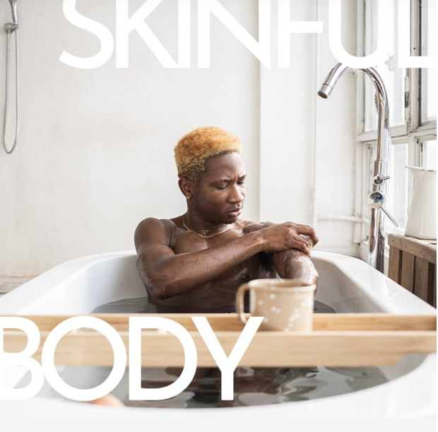 Male model in a bathtub scrubbing his arm